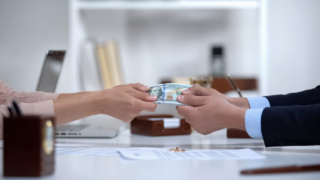 Male And Female Hands Pulling Money, Dividing Marital Property