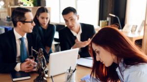 Oppressed red-haired woman signs document on deprivation of guardianship. Concept of deprivation of rights to child custody. Registration of guardianship of little girl.