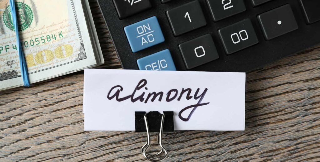 Alimony calculation concept with cash, calculator, and financial documents representing spousal support in divorce