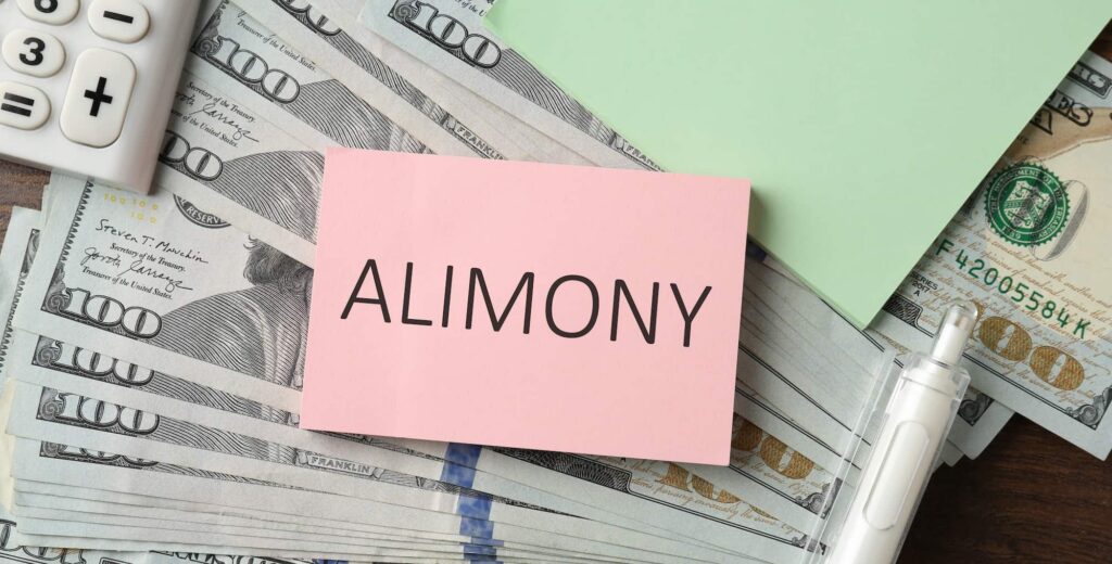Alimony payment concept with cash, calculator, and documents representing spousal support and financial obligations